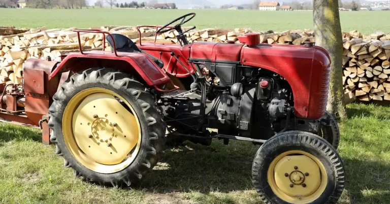 Tractor-mounted hydraulic wood splitter working through a pile of firewood