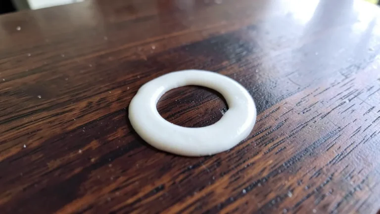 White ring water stain on a dark wood table surface