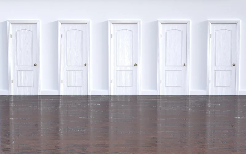 Open wooden doorway between two rooms of a home Open wooden doorway between two rooms of a home