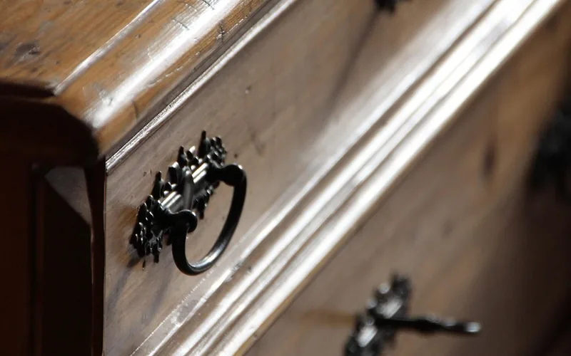 close-up of a wooden dresser drawer and hardware, the joints that loosen first when humidity swings close-up of a wooden dresser drawer and hardware, the joints that loosen first when humidity swings