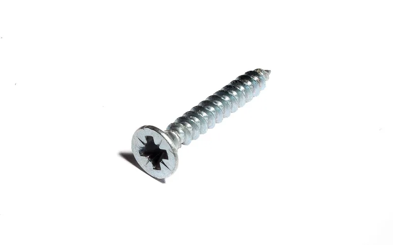 Close-up of a wood screw showing its wide, coarse threads