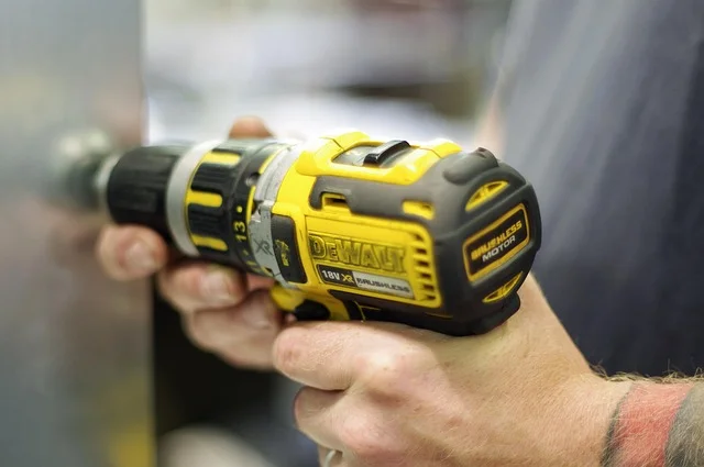 DEWALT cordless drill being used to drive a screw, held in a woodworker’s hands