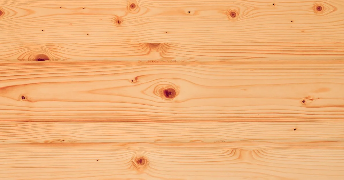 Knotty pine wood paneling boards with visible knots before painting