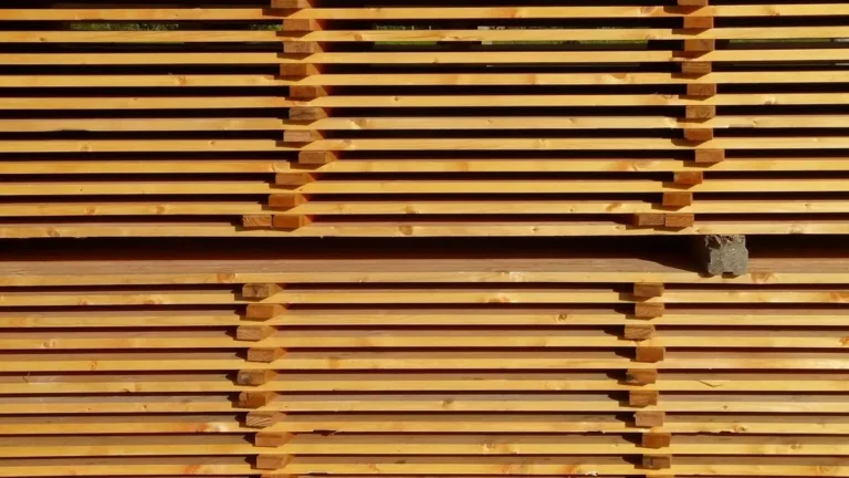 Stacked kiln-dried lumber boards separated by stickers