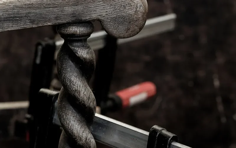 Long bar clamps holding a wooden chair spindle during a glue-up Long bar clamps holding a wooden chair spindle during a glue-up