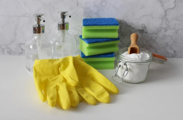 Cleaning supplies setup with gloves, sponges, soap and other materials
