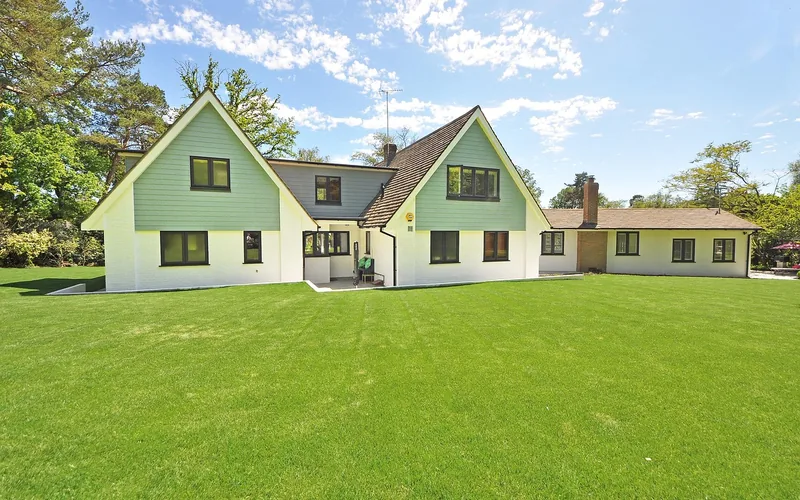 Home surrounded by cleared, well-maintained lawn creating defensible space from wildfire