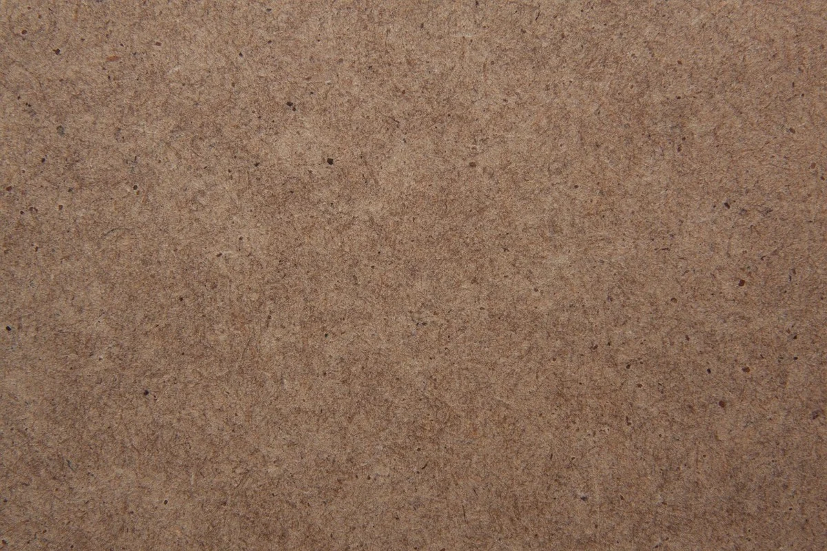 Close-up of the smooth brown surface of an MDF panel