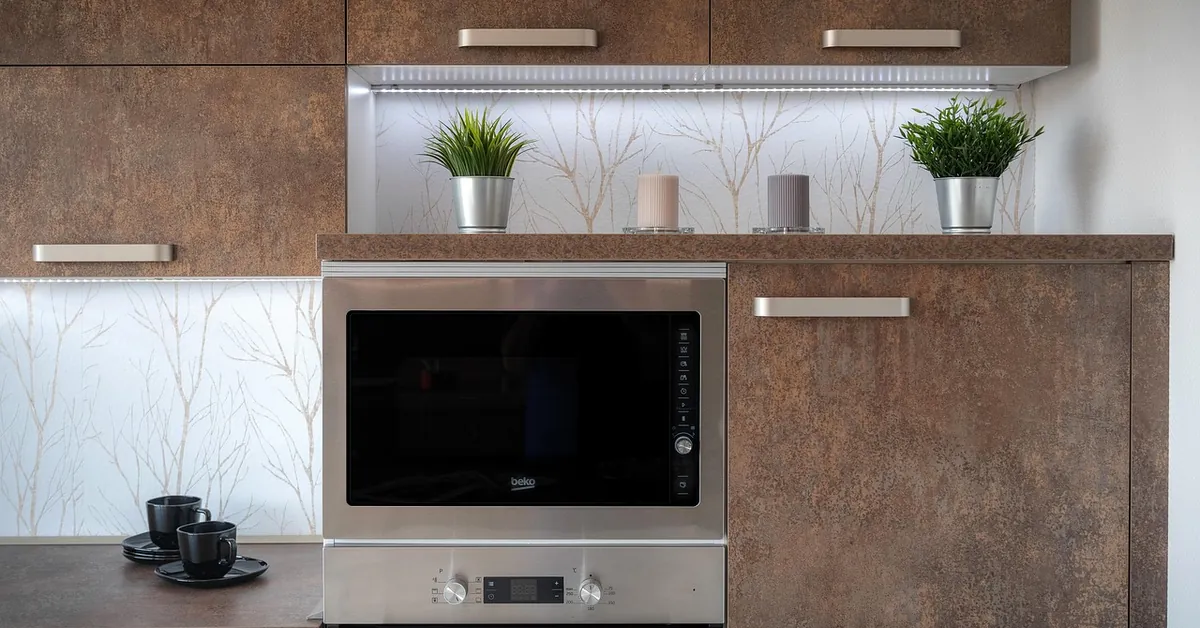 Kitchen with brown wood-look cabinets and stainless appliances
