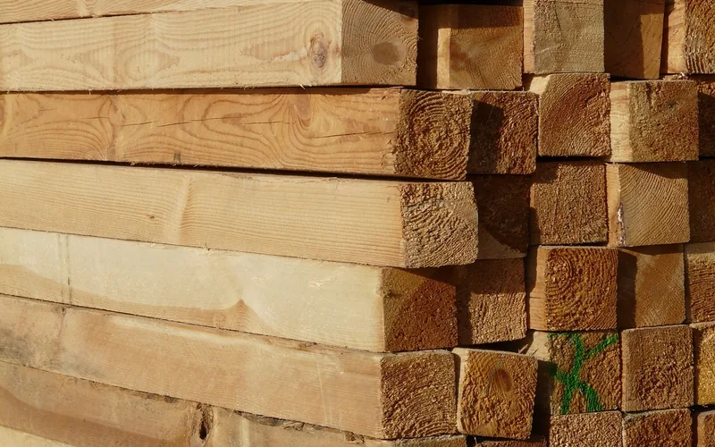 stack of sawn pressure treated lumber boards in storage