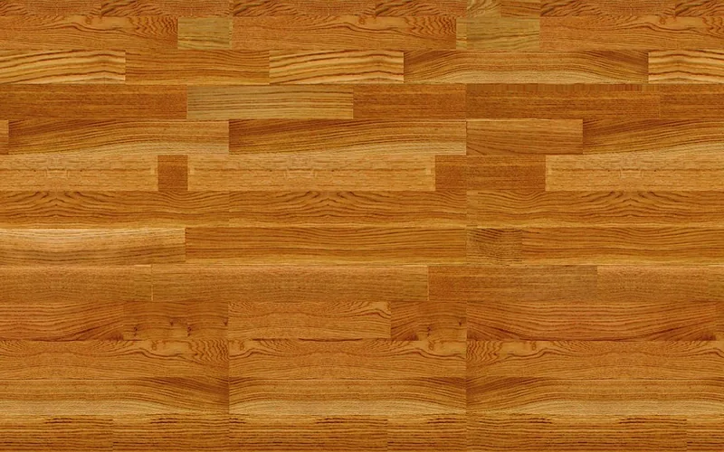 Solid hardwood parquet strips in warm tones showing grain variation Solid hardwood parquet strips in warm tones showing grain variation
