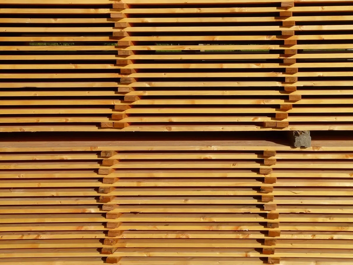 Sticker-stacked lumber boards air drying in tiers
