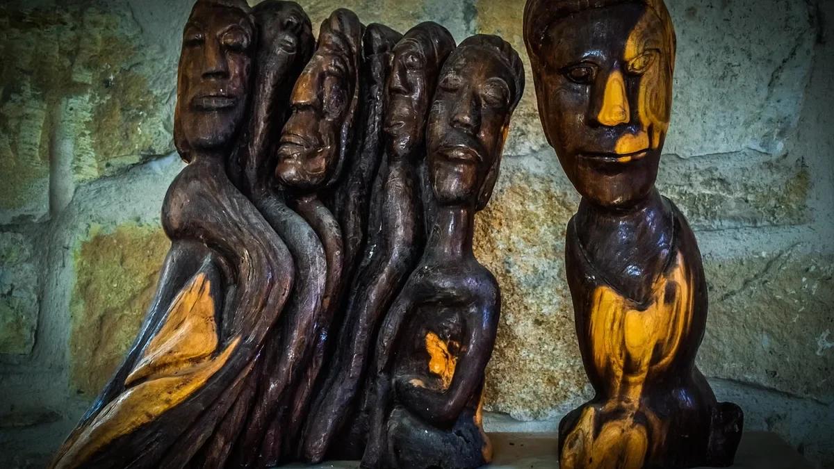Carved and polished wooden sculpture of flowing, grouped figures