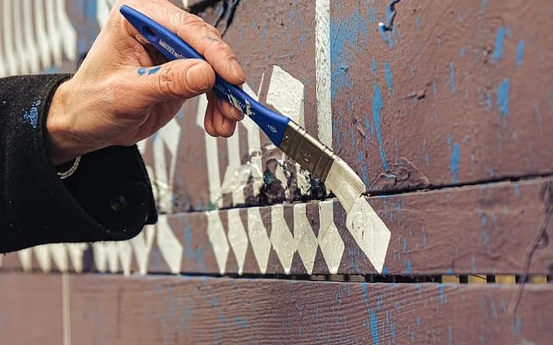 Applying cedar stain Applying semi-transparent cedar stain to exterior wood decking
