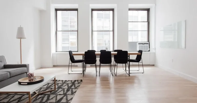Bright room with a clean hardwood plank floor and dining table