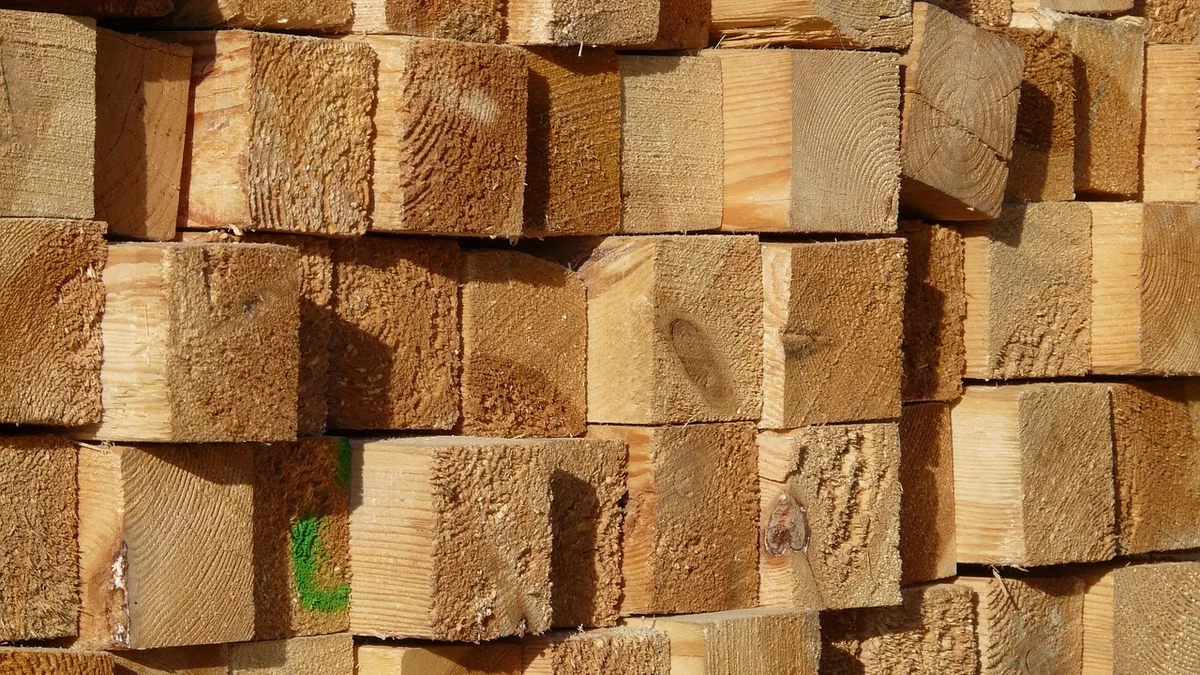 Stack of square-cut timbers seen end-on, showing 4x4 style lumber ends