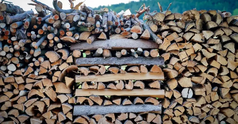 Split firewood stacked in tight rows on wooden pallets