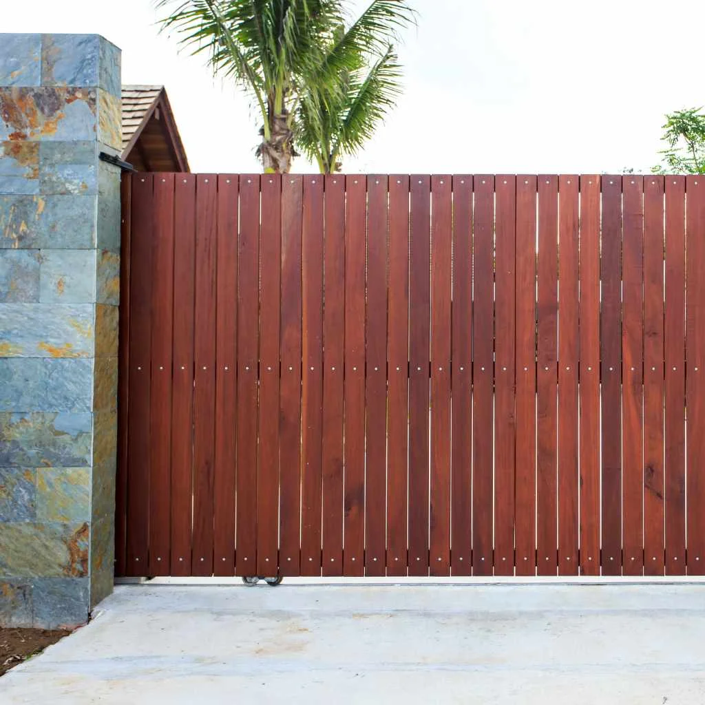 A finished wood fence panel attached along a metal-framed gate
