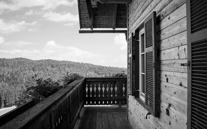 Wooden balcony railing with carved balusters on a timber house Wooden balcony railing with carved balusters on a timber house