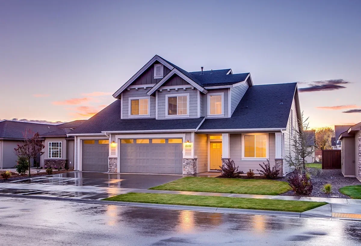 Two-car attached garage on a suburban house at dusk