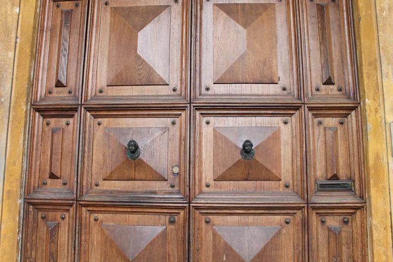 Stained raised-panel wood door showing panels, rails and stiles
