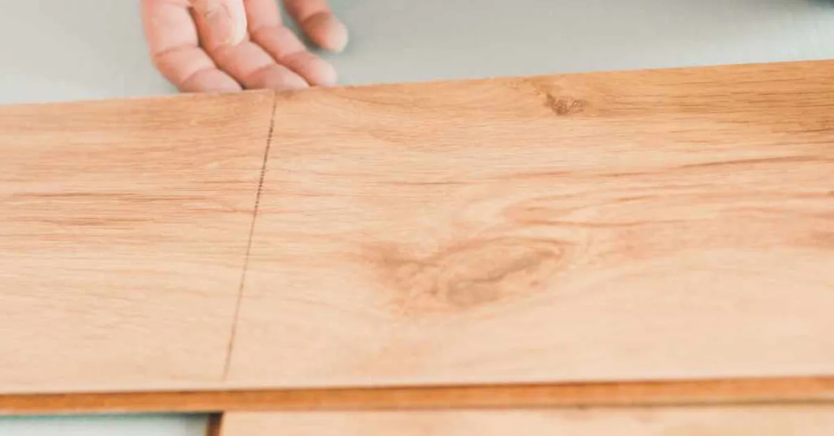 hand connecting click-lock floating floor planks over a foam underlayment pad hand connecting click-lock floating floor planks over a foam underlayment pad