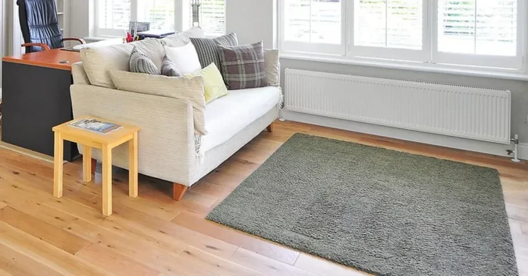Oak hardwood floor in a bright living room with sofa and rug