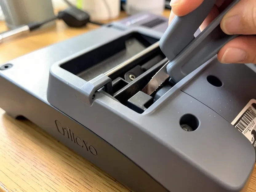 Inserting the Cricut Knife Blade into the machine clamp