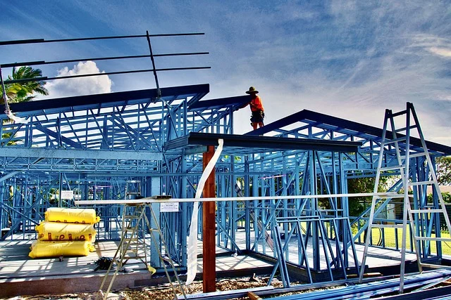 Steel frame construction with exposed metal studs and roof trusses on a job site