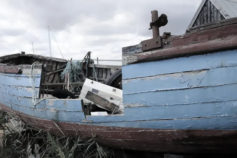Weathered wooden boat hull with peeling blue paint Weathered wooden boat hull with peeling blue paint