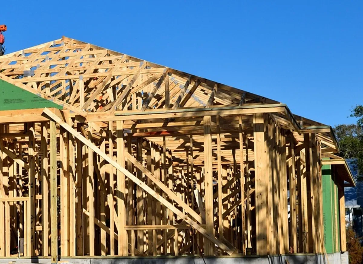 Wood wall studs, top plate and roof trusses on a framed building