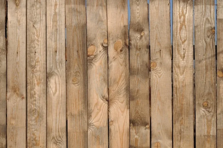 Natural wood privacy fence planks showing wood grain and knots