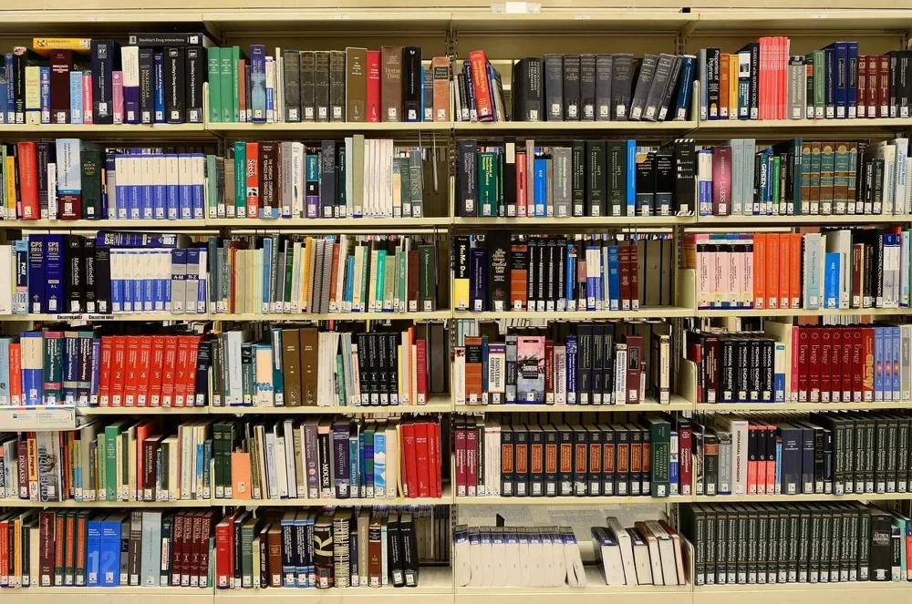Library shelves packed with heavy reference books
