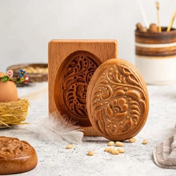 MOTEERLLU carved beech wood springerle cookie mold next to a pressed cookie