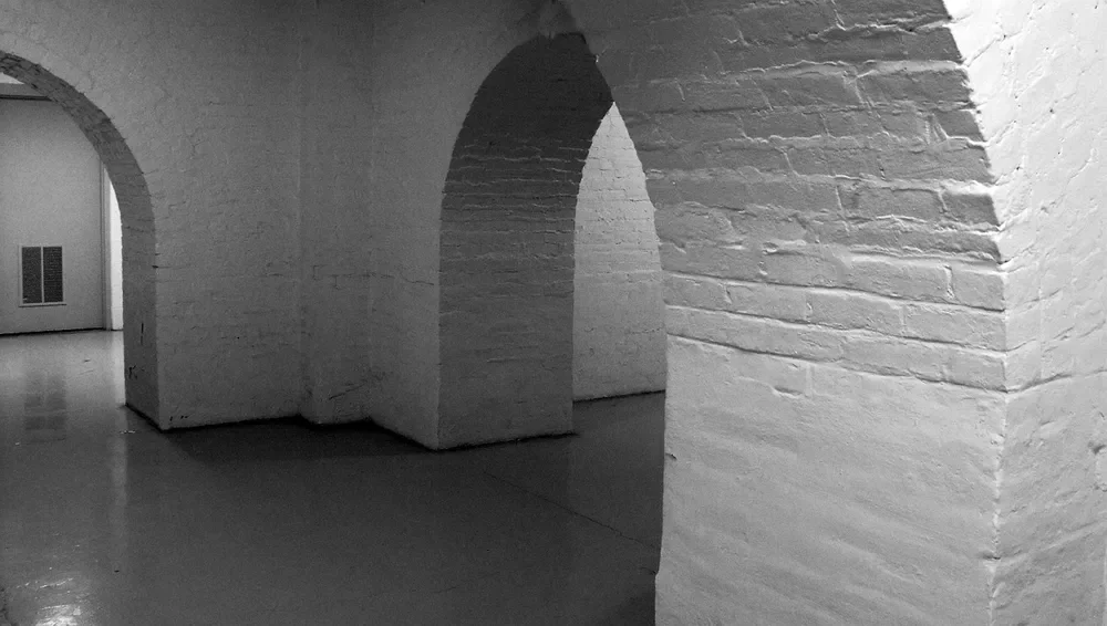 Painted brick basement walls and arches, a painted masonry surface that adhesive may not bond to