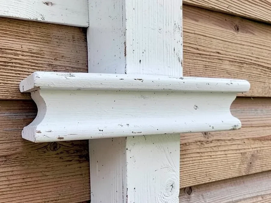 Painted pine exterior trim mounted against a house, an example of a non-ground-contact use where painted pine works well