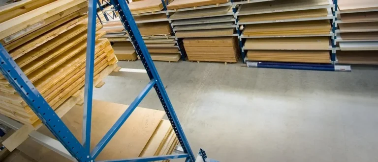 Sheets of plywood and lumber stacked on warehouse racks