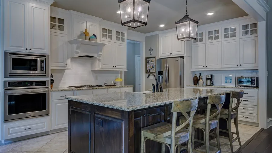 Kitchen with white raised-panel cabinets and a dark stained island