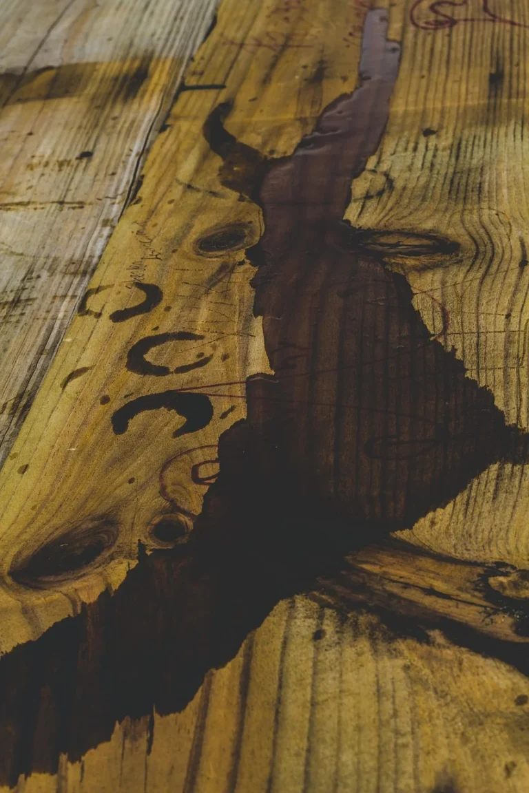 Dark water stain mark on a wood plank surface