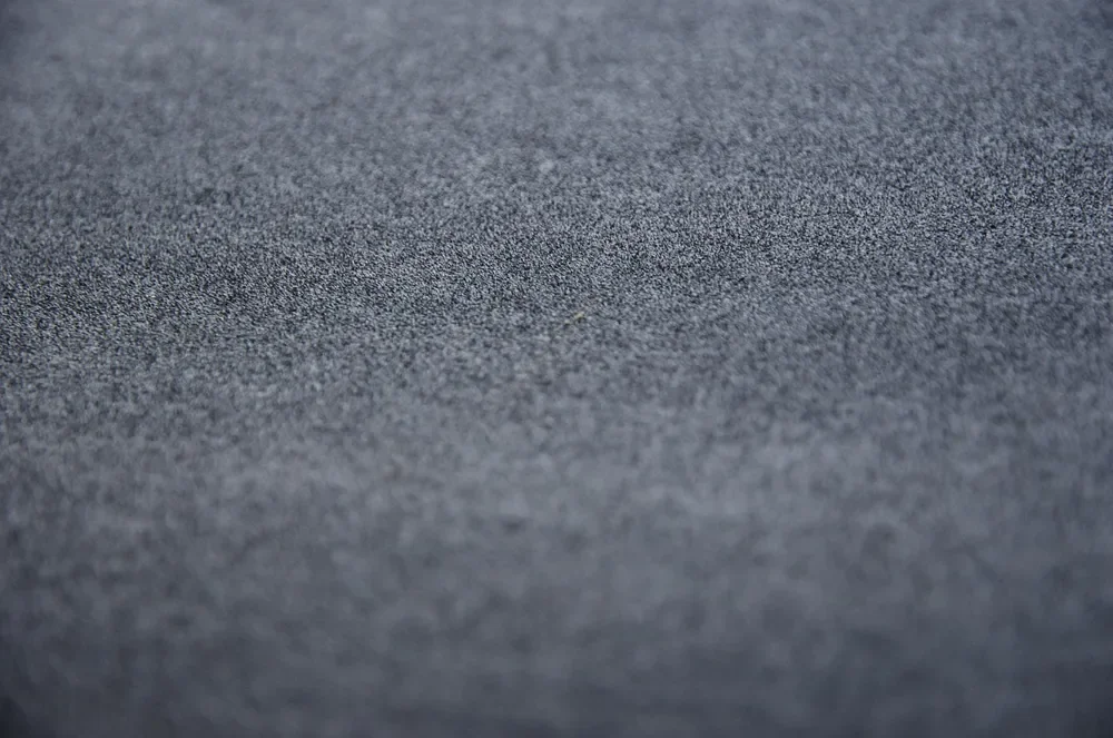Close-up of the gritty abrasive surface of a sheet of sandpaper