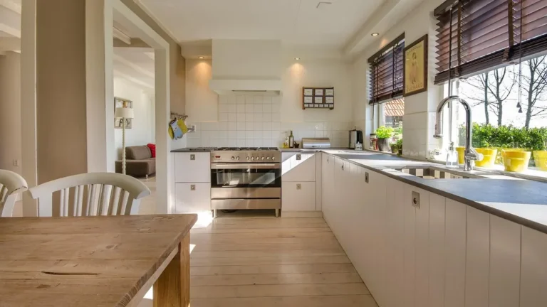 Kitchen with white flat-panel slab-door cabinets and a light wood floor