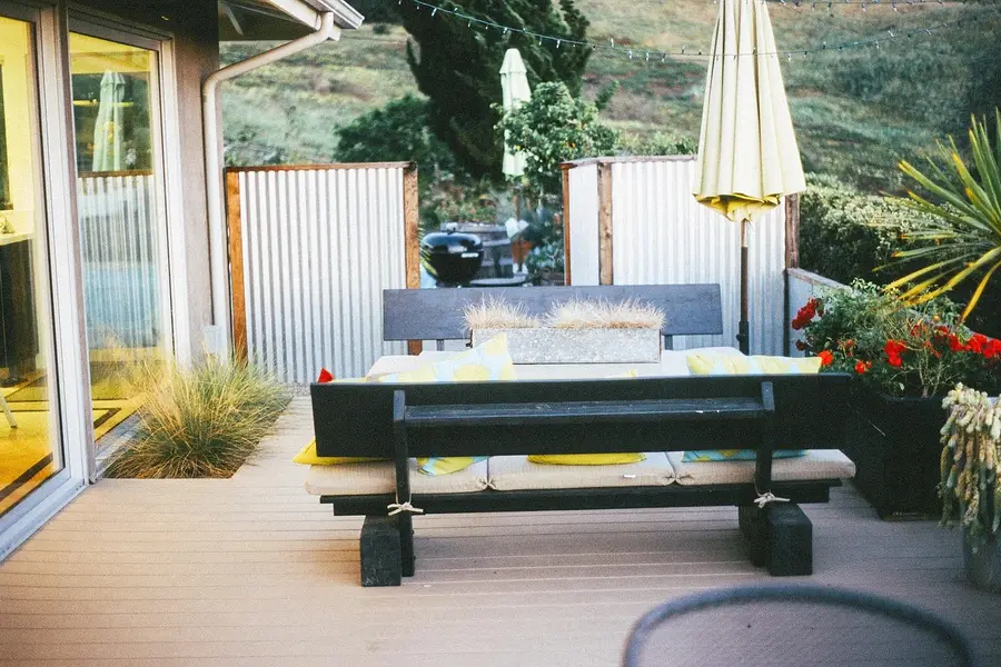 A finished composite deck patio seating area with uniform color composite boards A finished composite deck patio seating area with uniform color composite boards