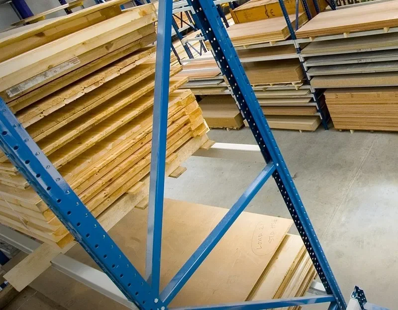 Plywood sheets and boards stored flat on warehouse racking
