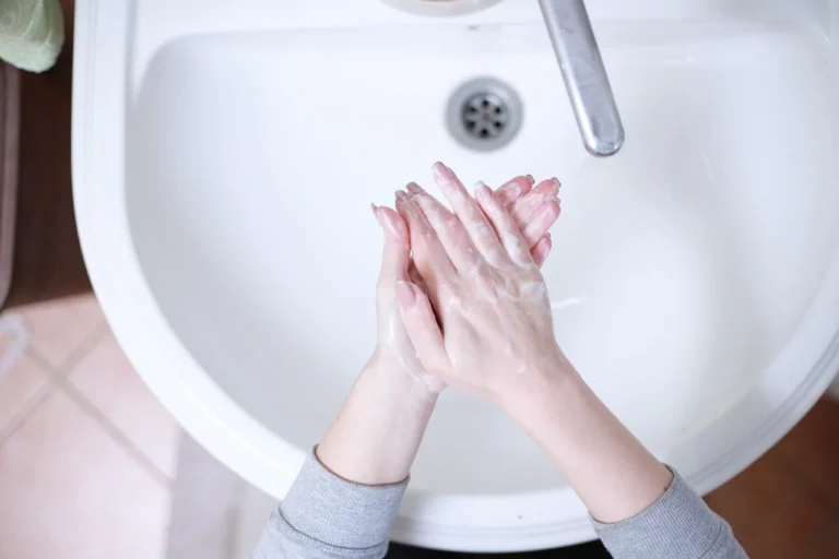 Washing hands with soap at a sink