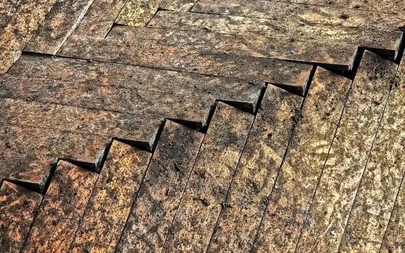 severely gapped and warped hardwood floor planks showing damage beyond a simple DIY filler repair
