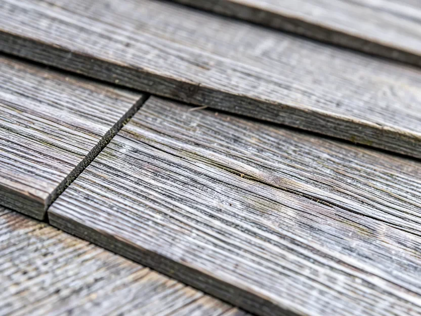 Close-up of weathered natural cedar shingles showing wood grain and silvery patina