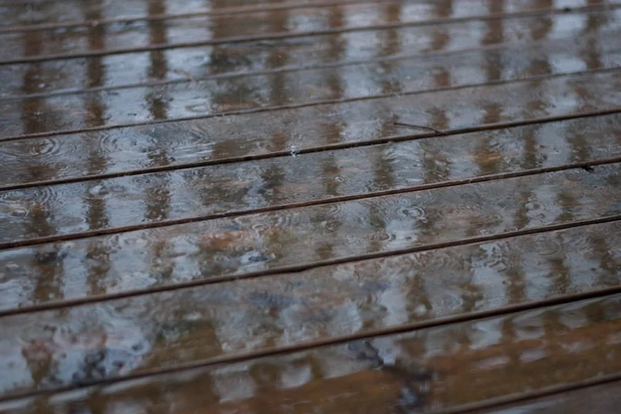 Rain water pooling between wood deck boards Rain water pooling between wood deck boards