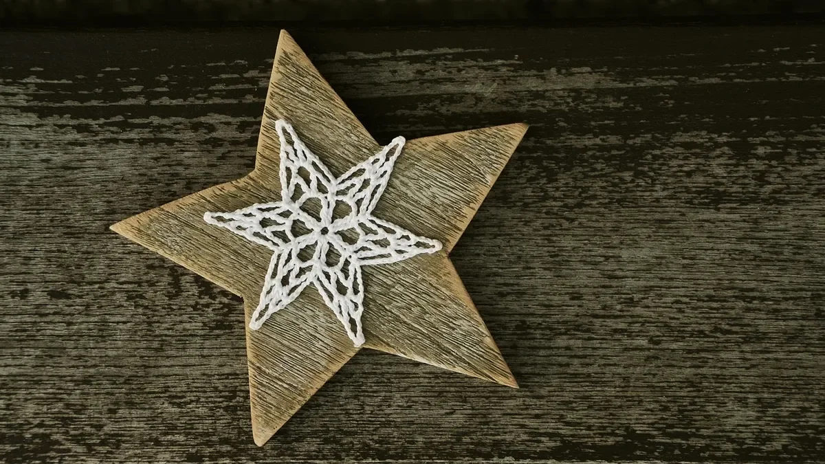 Wooden Christmas star decoration on weathered wood boards