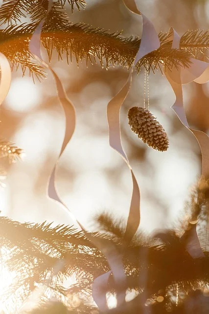 Painted pine cone used as a hanging Christmas ornament