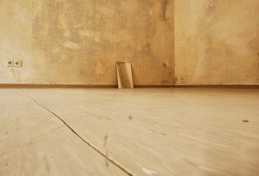A dull, worn wood floor with a cloudy film typical of old wax buildup before stripping A dull, worn wood floor with a cloudy film typical of old wax buildup before stripping